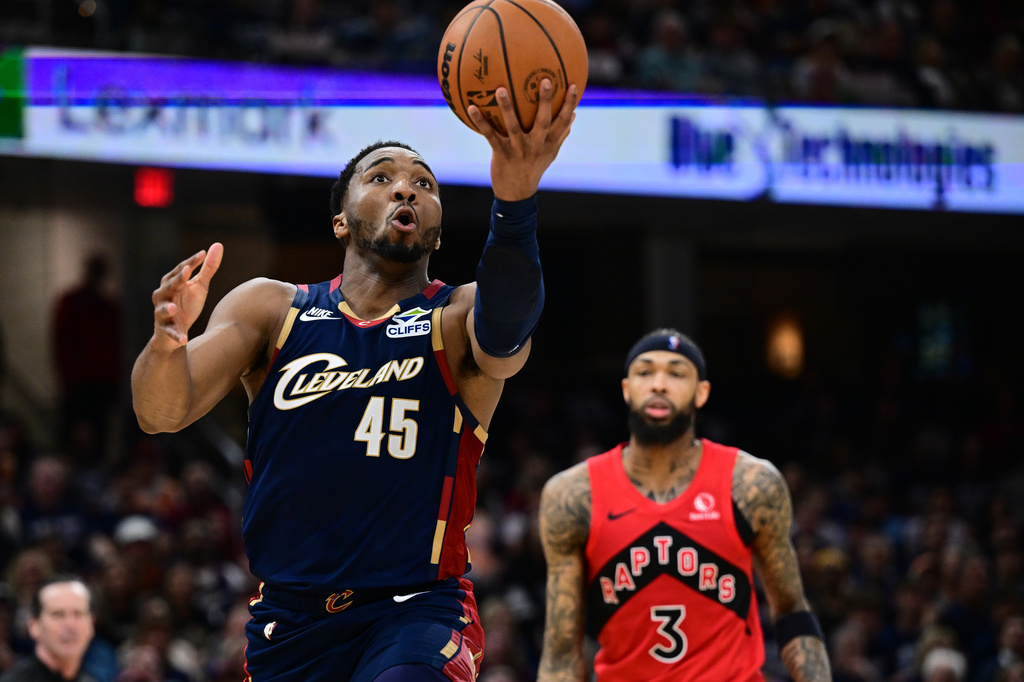 Cleveland Cavaliers guard Donovan Mitchell goes to the basket against the Toronto Raptors during the second half in Game 1 of a first-round NBA playoffs basketball series, Saturday, April 18, 2026, In Cleveland. (AP Photo/David Dermer)