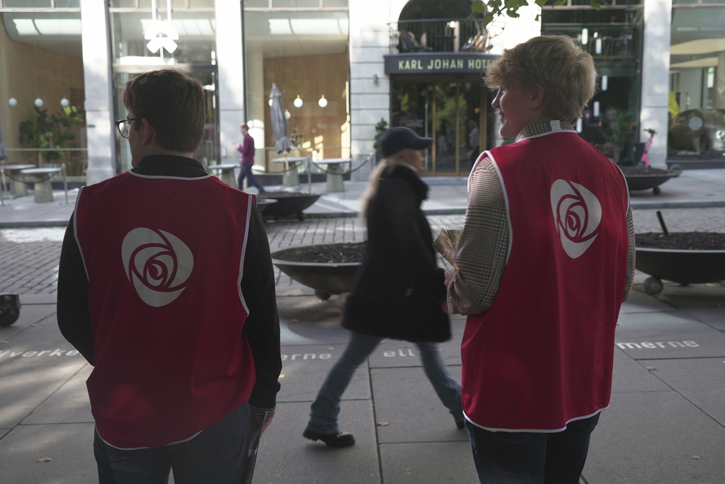 Campaign volunteers from the Labour Party stand on the sidewalk looking for people to engage with in Oslo, Sunday, Sept. 7, 2025. (AP Photo/Kostya Manenkov)
