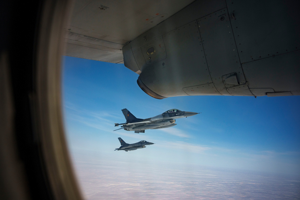 FILE - Romanian Air Force F-16 military fighter jets escort a C-27J Spartan aircraft during a NATO Air Policing exercise above eastern Romania, on March 6, 2024. (AP Photo/Andreea Alexandru, File)
