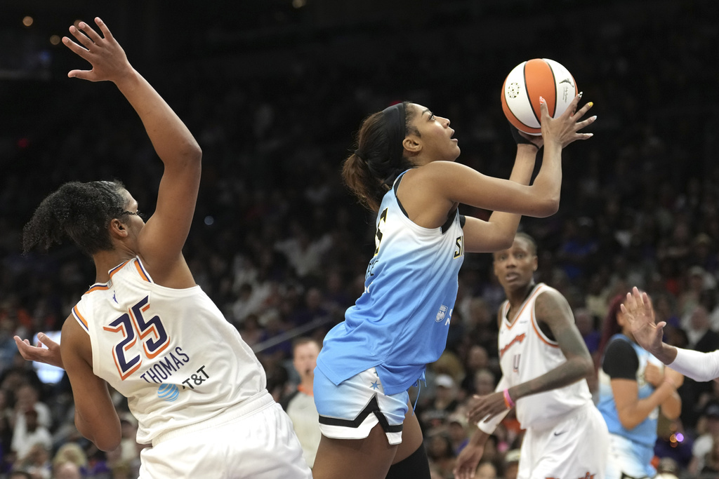 Chicago Sky forward Angel Reese, right, drives past Phoenix Mercury forward Alyssa Thomas (25) to score during the second half of a WNBA basketball game Thursday, Aug. 28, 2025, in Phoenix. (AP Photo/Ross D. Franklin)