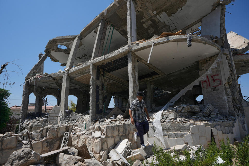 A Lebanese man checks a destroyed house in the village of Zawtar al-Gharbieh, south Lebanon, Wednesday, Aug. 5, 2026. (AP Photo/Mohammed Zaatari)