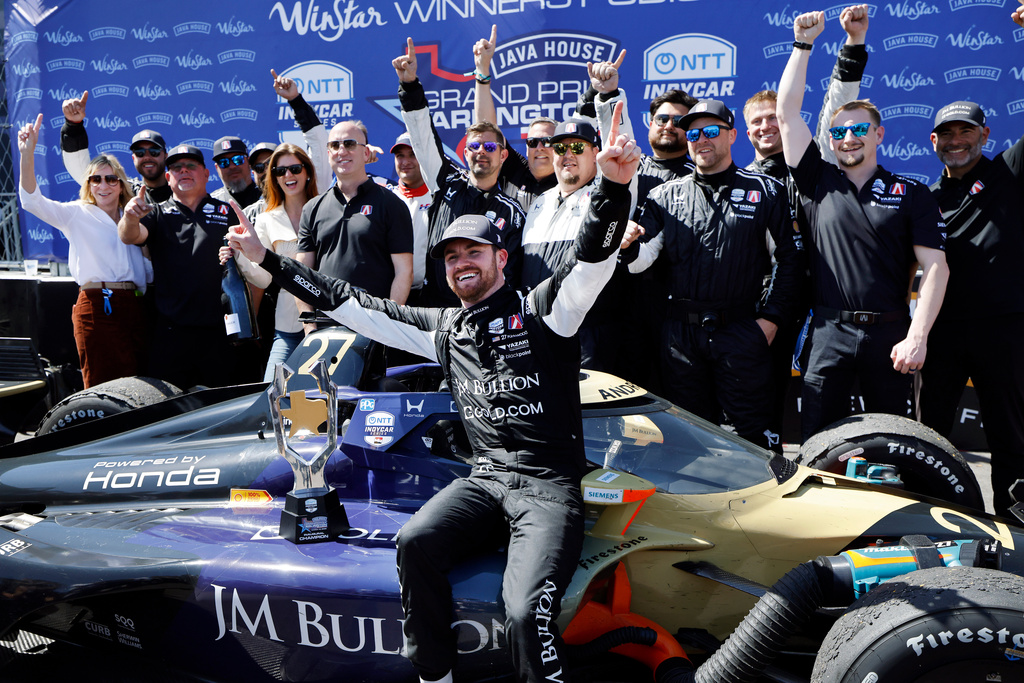 Grand Prix of Arlington winning driver Kyle Kirkwood of Andretti Global, center, poses for photos with his crew following at the Grand Prix of Arlington auto race, Sunday, March 15, 2026, in Arlington, Texas. (Tome Fox/The Dallas Morning News via AP)