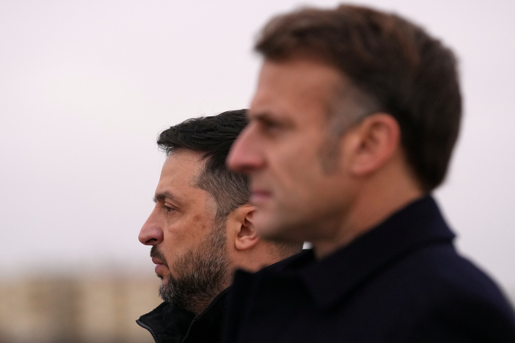 French President Emmanuel Macron, right, and Ukrainian President Volodymyr Zelenskyy listen to national anthems, Monday, Nov. 17, 2025 at the Villacoublay air base near Paris. (AP Photo/Christophe Ena, Pool)