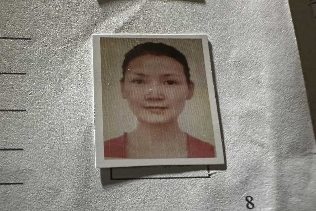 A picture of Chinese climber Guan Jing, who was killed on K2, the world's second-highest peak, is seen on a document, which shown by Shahbaz Khan, station manager of a Pakistani tour operator "Imagine Club Pakistan" at his office in Skardu, in northern Pakistan, Saturday, Aug. 16, 2025. (AP Photo/M.H. Balti)