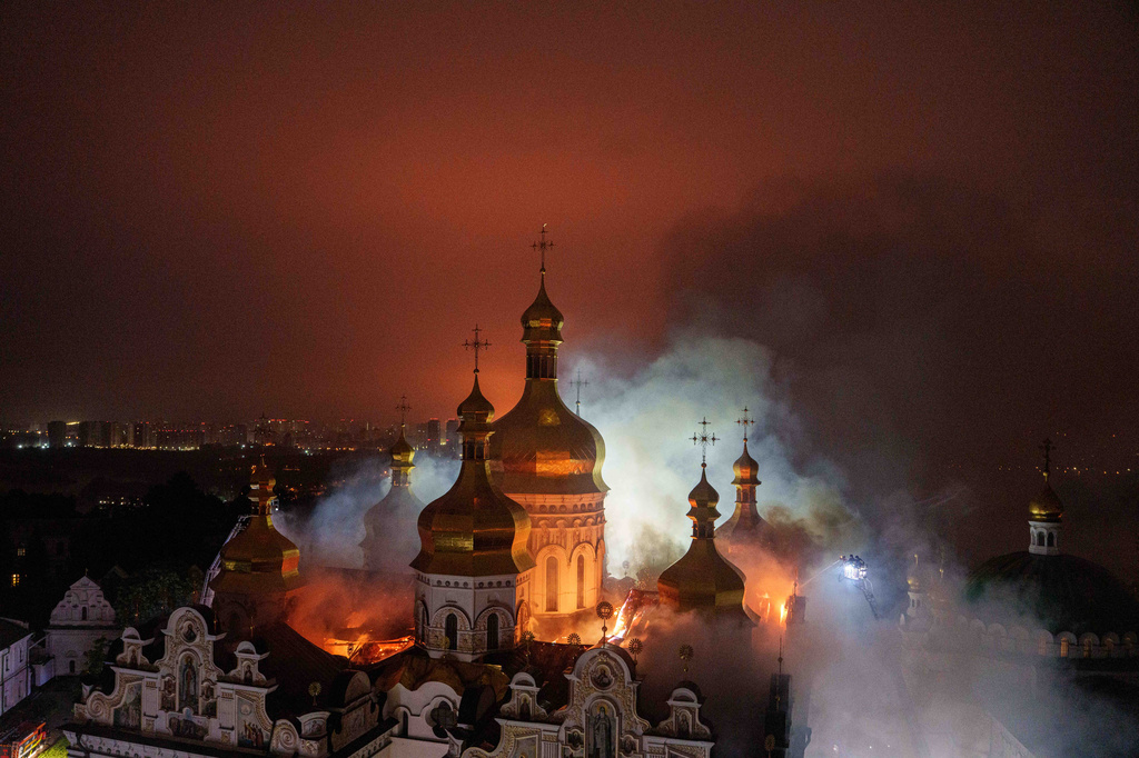 Rescue workers put out a fire of the Dormition Cathedral of the Kyiv-Pechersk Lavra, also known as the Monastery of the Caves during a Russian strike on Kyiv, Ukraine, on Monday, June 15, 2026. (AP Photo/Evgeniy Maloletka)