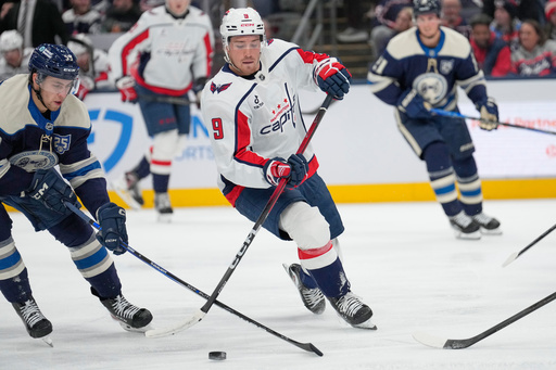 Columbus Blue Jackets right wing Yegor Chinakhov,, left, and Washington Capitals right wing Ryan Leonard (9) reach for the puck in the second period of an NHL hockey game Friday, Oct. 24, 2025, in Columbus, Ohio. (AP Photo/Sue Ogrocki) Columbus Blue Jackets right wing Yegor Chinakhov,, left, and Washington Capitals right wing Ryan Leonard (9) reach for the puck in the second period of an NHL hockey game Friday, Oct. 24, 2025, in Columbus, Ohio. (AP Photo/Sue Ogrocki)