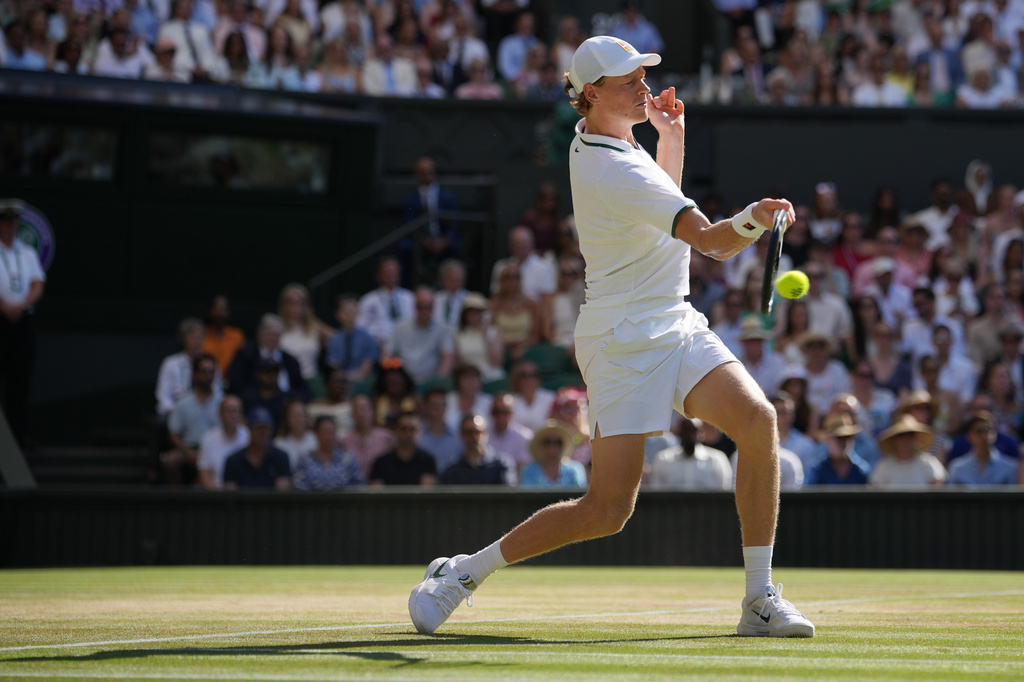 Jannik Sinner of Italy stretches to play a return to Alexander Zverev of Germany during the men's singles final at Wimbledon Tennis Championships in London, Sunday, July 12, 2026. (AP Photo/Kin Cheung)