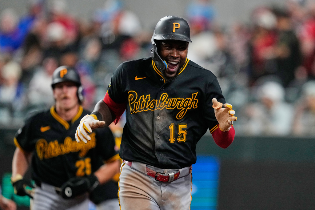 Pittsburgh Pirates' Oneil Cruz (15) celebrates after hitting a three-run home run in the ninth inning of a baseball game against the Texas Rangers Wednesday, April 22, 2026, in Arlington, Texas. (AP Photo/Tony Gutierrez)