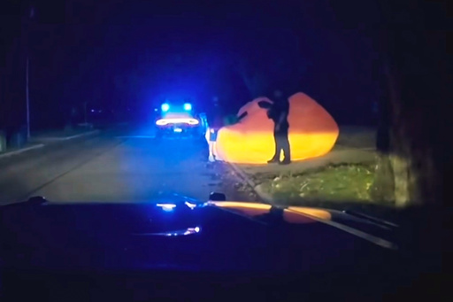 This image made from a Parma Heights Police Department body camera video shows a police officer approaching a runaway inflatable pumpkin on Tuesday, Oct. 7, 2025. (Parma Heights Police Department via AP) This image made from a Parma Heights Police Department body camera video shows a police officer approaching a runaway inflatable pumpkin on Tuesday, Oct. 7, 2025. (Parma Heights Police Department via AP)