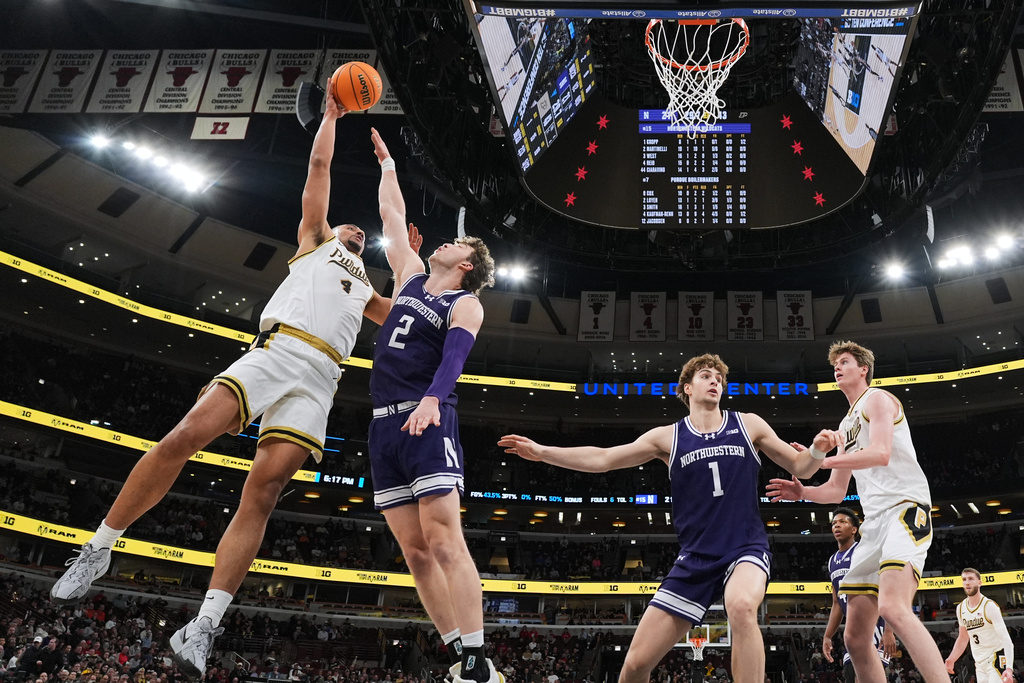 Purdue forward Trey Kaufman-Renn, left, shoots over Northwestern forward Nick Martinelli (2) during the first half of an NCAA college basketball game in the third round of the Big 10 Conference tournament, Thursday, March 12, 2026, in Chicago. (AP Photo/Nam Y. Huh)