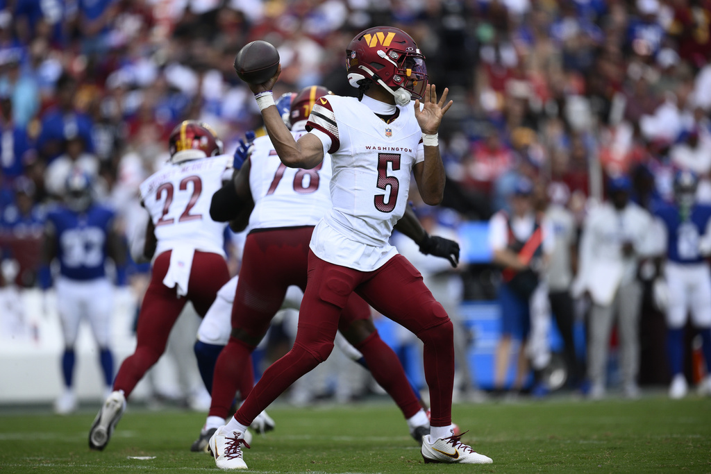 Washington Commanders quarterback Jayden Daniels (5) passes the ball during the second half of an NFL football game against the New York Giants, Sunday, Sept. 7, 2025, in Landover, Md. (AP Photo/Nick Wass)