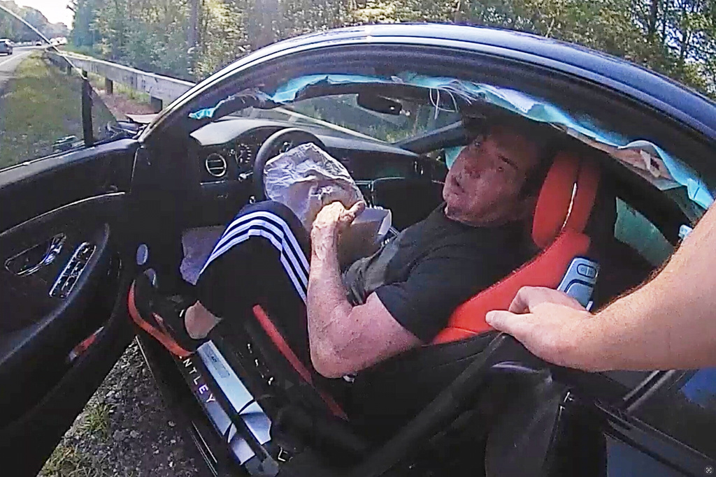 In an image taken from Connecticut State Police police bodycam video, Vince McMahon is questioned in his car after an accident on July 24, 2025, in Westport, Conn. (Connecticut State Police via AP)