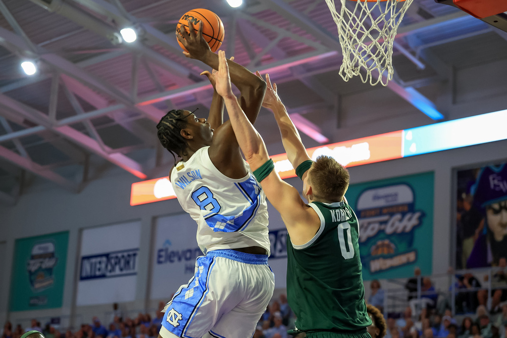 North Carolina forward Caleb Wilson, left, is fouled by Michigan State forward Jaxon Kohler, right, during the first half of an NCAA college basketball game Thursday, Nov. 27, 2025, in Fort Myers, Fla. (AP Photo/Mike Carlson)