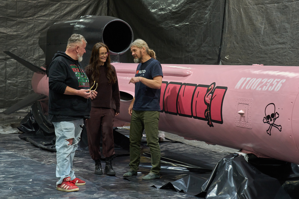 Jan Polak, right, and Martin Ondracek, left, from the Czech organization, Weapons to Ukraine, chat with Iryna Terekh, Chief Technology Officer of the Fire Point factory at a Flamingo cruise missile, which was paid for by Czech crowdfunding campaign, at the Fire Point factory at an undisclosed location in Ukraine, Sunday, Nov. 16, 2025. (AP Photo/Efrem Lukatsky)