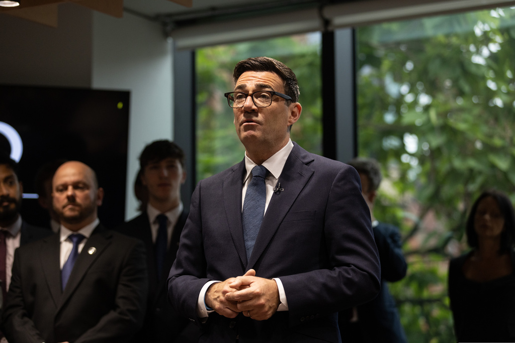 Britain's Prime Minister Andy Burnham arrives and greets staff at No 10 North, in Manchester, England, Friday, July 24, 2026. (James Speakman/Pool photo via AP)