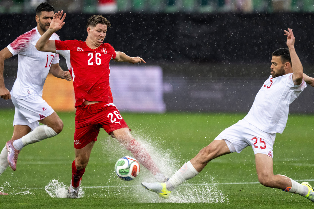 Switzerland's Cedric Itten, left, fights for the ball with Jordan's Mohammad Al-Dawoud during the international friendly soccer match between Switzerland and Jordan in St. Gallen, Switzerland, Sunday, May 31, 2026. (Peter Schneider/Keystone via AP)