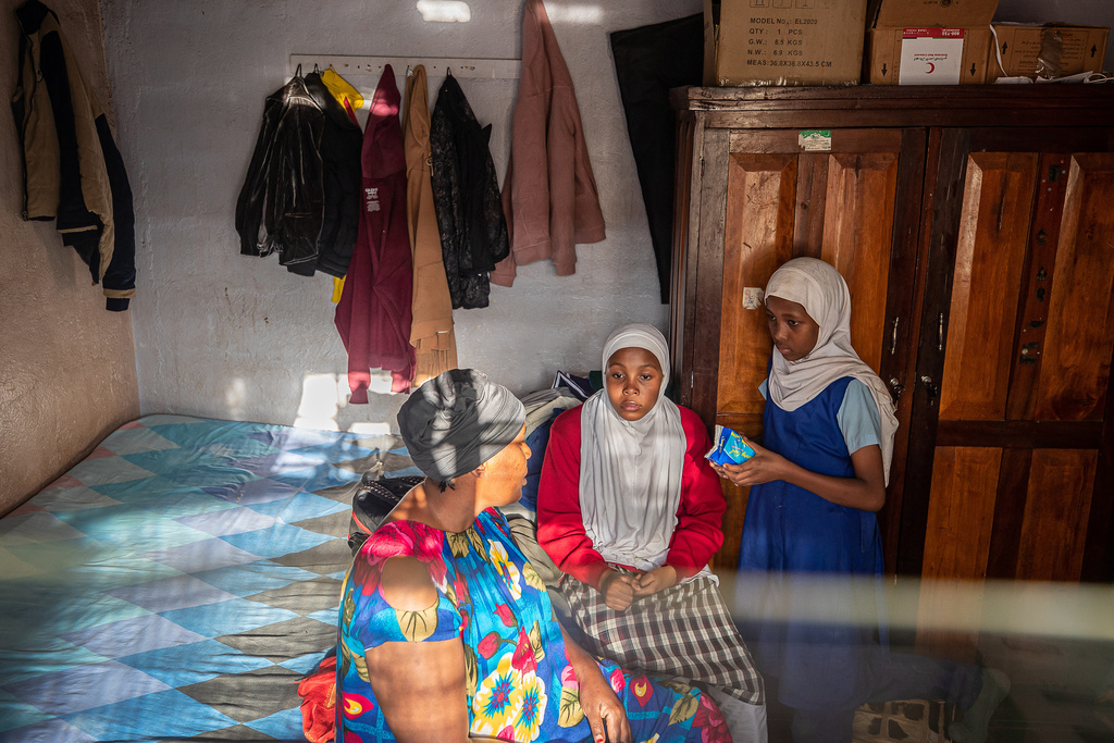 Alima Nasur talks to her daughters, Salama Halima, 13, center, and Buthaina Halima, 11, right, about menstrual health inside their home in the Kibera informal settlement on the outskirts of Nairobi, Kenya, Feb. 12, 2026. (AP Photo/Atieno Muyuyi)