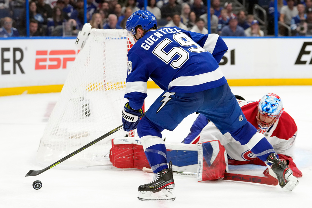 Tampa Bay Lightning center Jake Guentzel (59) chases the puck after a save by Montréal Canadiens goaltender Jakub Dobes (75) during the second period in Game 2 of an NHL hockey Stanley Cup first-round playoff series, Tuesday, April 21, 2026, in Tampa, Fla. (AP Photo/Chris O'Meara)