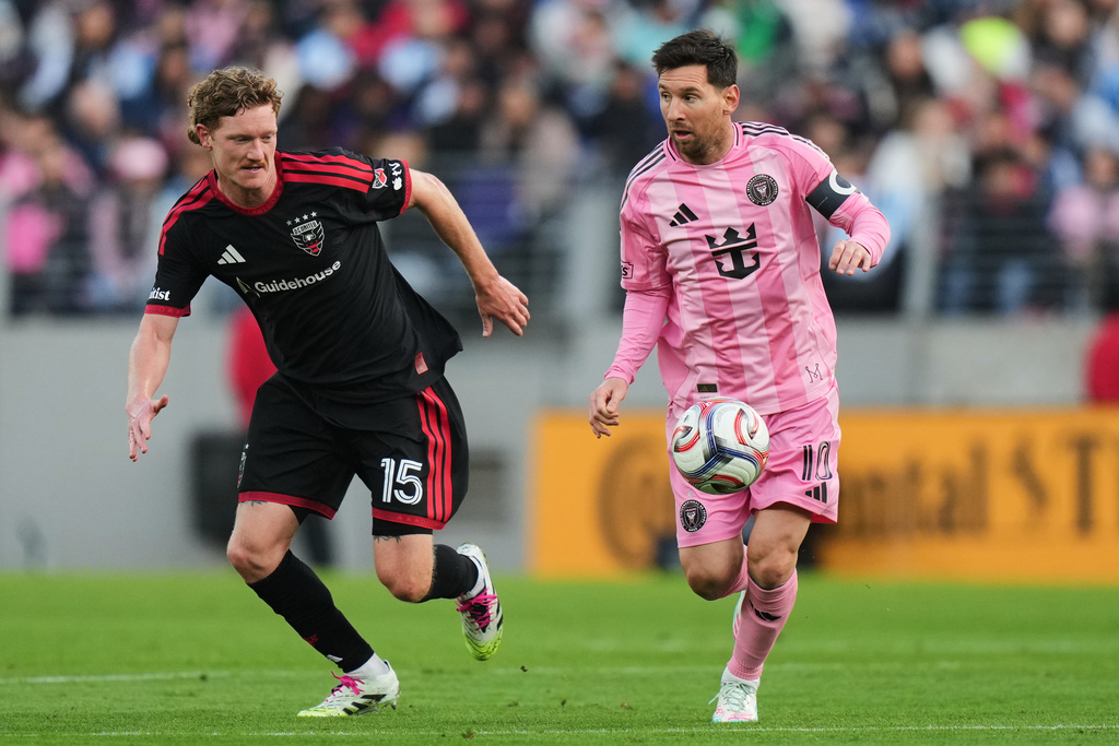 Inter Miami forward Lionel Messi, right, advances past D.C. United defender Kye Rowles (15) during the first half of an MLS soccer match, Saturday, March 7, 2026, in Baltimore. (AP Photo/Stephanie Scarbrough)