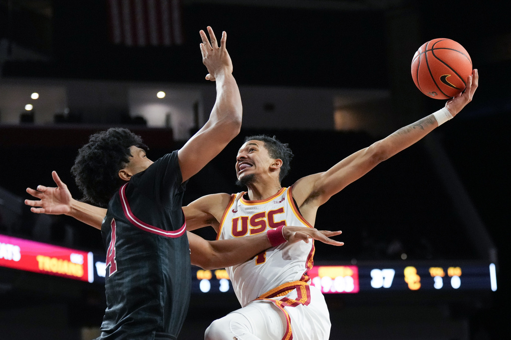 Southern California forward Chad Baker-Mazara, right, goes up for a basket against Indiana forward Sam Alexis during the second half of an NCAA college basketball game in Los Angeles, Tuesday, Feb. 3, 2026. (AP Photo/Jae C. Hong)
