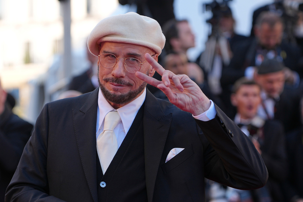 John Travolta poses for photographers upon arrival at the premiere of the film 'Karma' at the 79th international film festival, Cannes, southern France, Friday, May 15, 2026. (AP Photo/Andreea Alexandru)