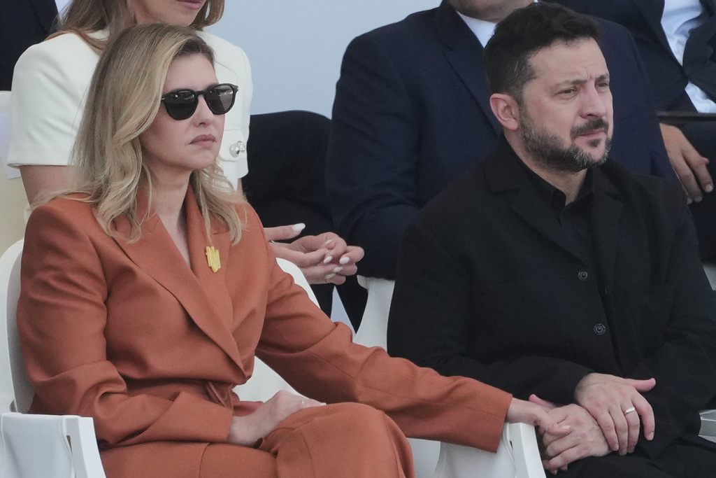 Ukraine's President Volodymyr Zelensky and his wife Olena Zelenska attend the Bastille Day military parade on the Champs-Elysees avenue, in Paris, Tuesday, July 14, 2026. (AP Photo/Michel Euler)