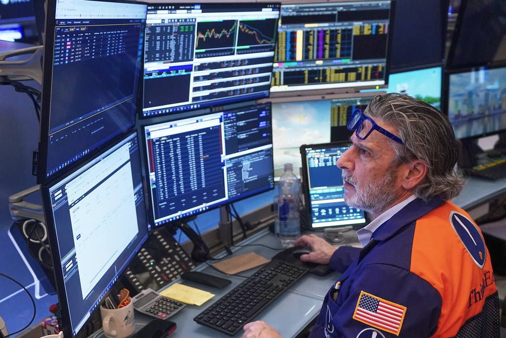 Trader John Romolo works on the floor of the New York Stock Exchange, Friday, Feb. 20, 2026. (AP Photo/Richard Drew)