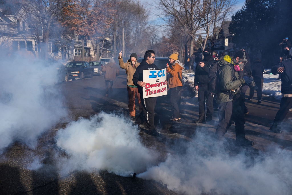 EDS NOTE: OBSCENITY - Tear gas is deployed amid protesters near the scene where Renee Good was fatally shot by an ICE officer last week, Tuesday, Jan. 13, 2026, in Minneapolis. (AP Photo/John Locher)