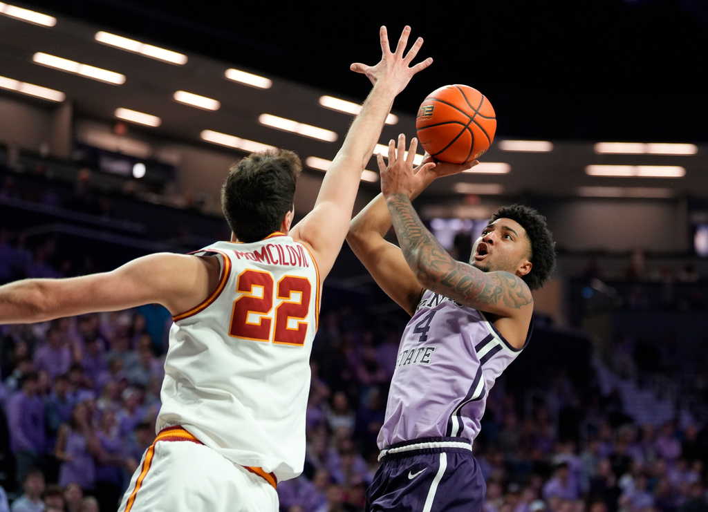 Kansas State guard PJ Haggerty (4) looks for a shot against Iowa State forward Milan Momcilovic (22) during the second half of an NCAA college basketball game, Sunday, Feb. 1, 2026, in Manhattan, Kan. (AP Photo/Nick Krug)