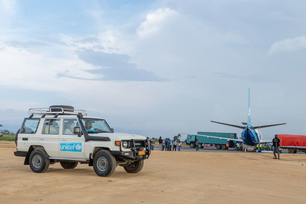 People wait in a UNICEF vehicle at Bunia National Airport ahead of the arrival of supplies as part of the response to the Ebola outbreak in Bunia, Congo, Tuesday, May 19, 2026. (AP Photo/Moses Sawasawa)