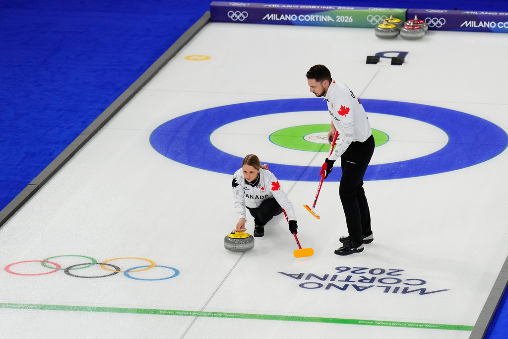 Jocelyn Peterman and Brett Gallant, of Canada, compete during a curling mixed doubles round robin session at the 2026 Winter Olympics, in Cortina d'Ampezzo, Italy, Friday, Feb. 6, 2026. (AP Photo/David J. Phillip)