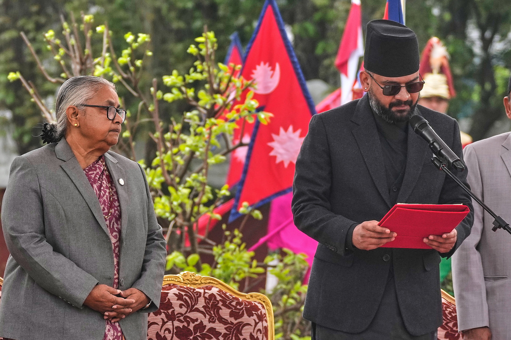 Nepal's former Chief Justice and interim Prime Minister Sushila Karki, left, watches as Nepal's youngest prime minister Balendra Shah, takes the oath of office at a function in Kathmandu, Nepal, Friday, March 27, 2026. (AP Photo/Niranjan Shrestha)