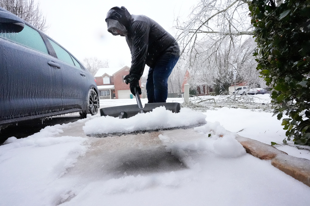 David Bentley shovels ice and snow from his driveway during a winter storm Sunday, Jan. 25, 2026, in Nashville, Tenn. (AP Photo/George Walker IV)