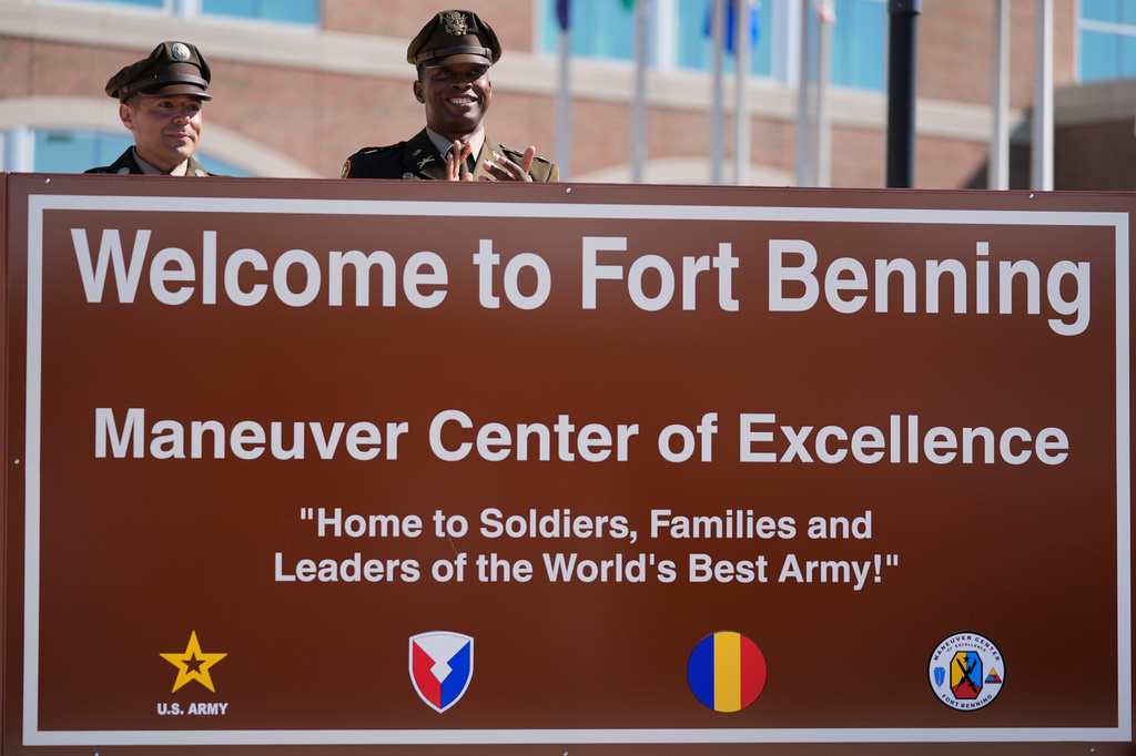 FILE - Members of the Army military stand behind a new sign at Fort Benning during a ceremony, April 16, 2025, in Fort Benning, Ga. (AP Photo/Brynn Anderson, File)