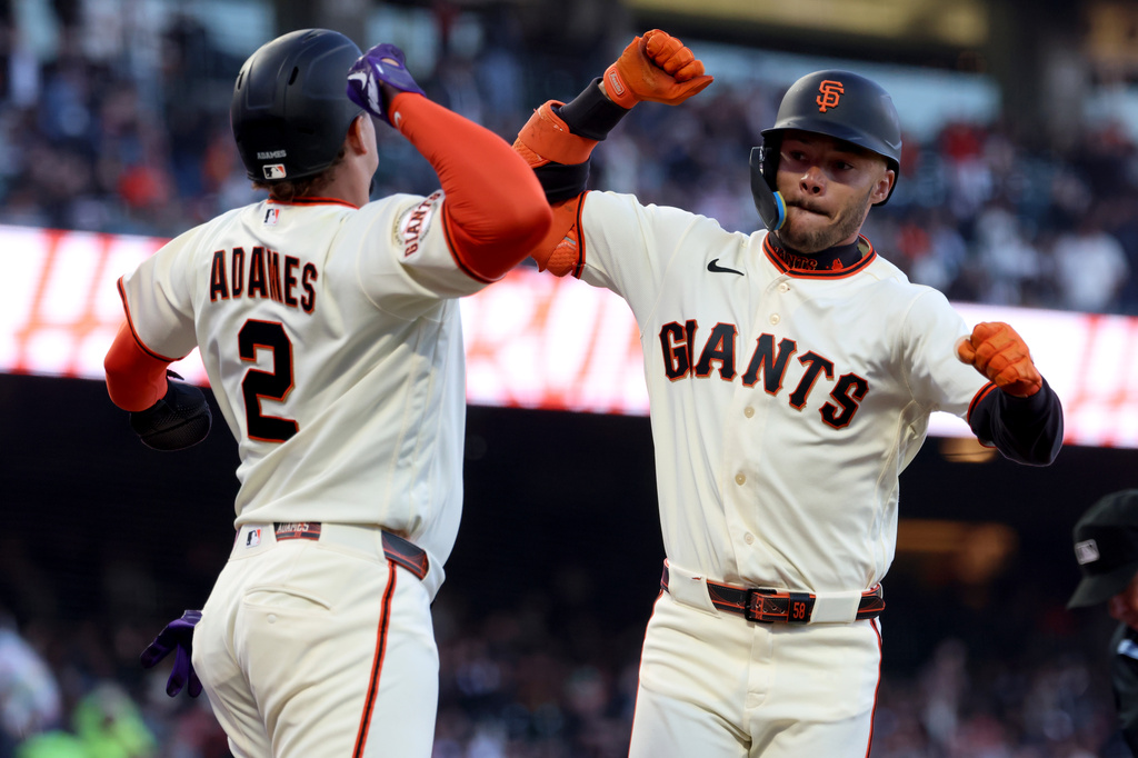 San Francisco Giants' Grant McCray, right, celebrates with Willy Adames (2) after hitting a two-run home run during the fourth inning of a baseball game against the Milwaukee Brewers in San Francisco, Monday, July 27, 2026. (AP Photo/Jed Jacobsohn)