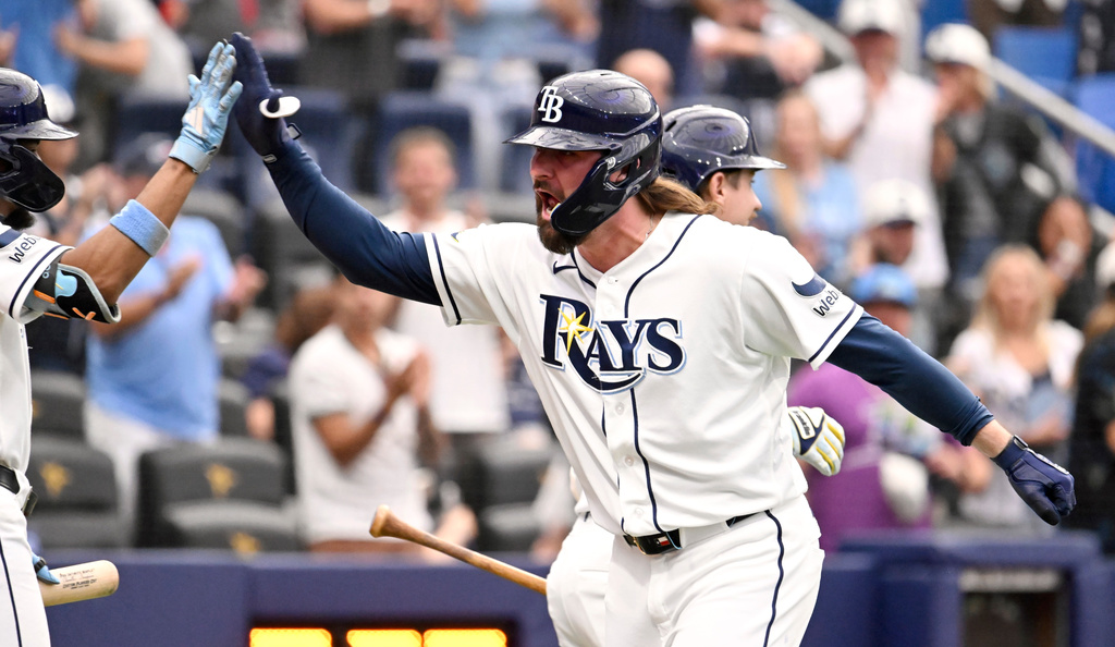 Tampa Bay Rays' Ryan Vilade, front right, celebrates after his three-run home run during the seventh inning of a baseball game against the Seattle Mariners, Saturday, July 11, 2026, in St. Petersburg, Fla. (AP Photo/Jason Behnken)
