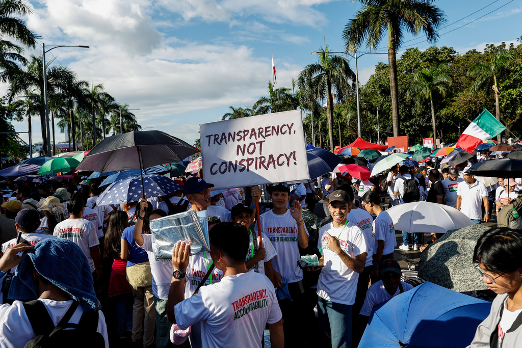 Members of the religious sect Iglesia Ni Cristo (Church of Christ) hold a placard as they participate in a three-day anti-corruption rally at Manila's Rizal Park, Philippines, Sunday, Nov. 16, 2025. (AP Photo/Mark Cristino)