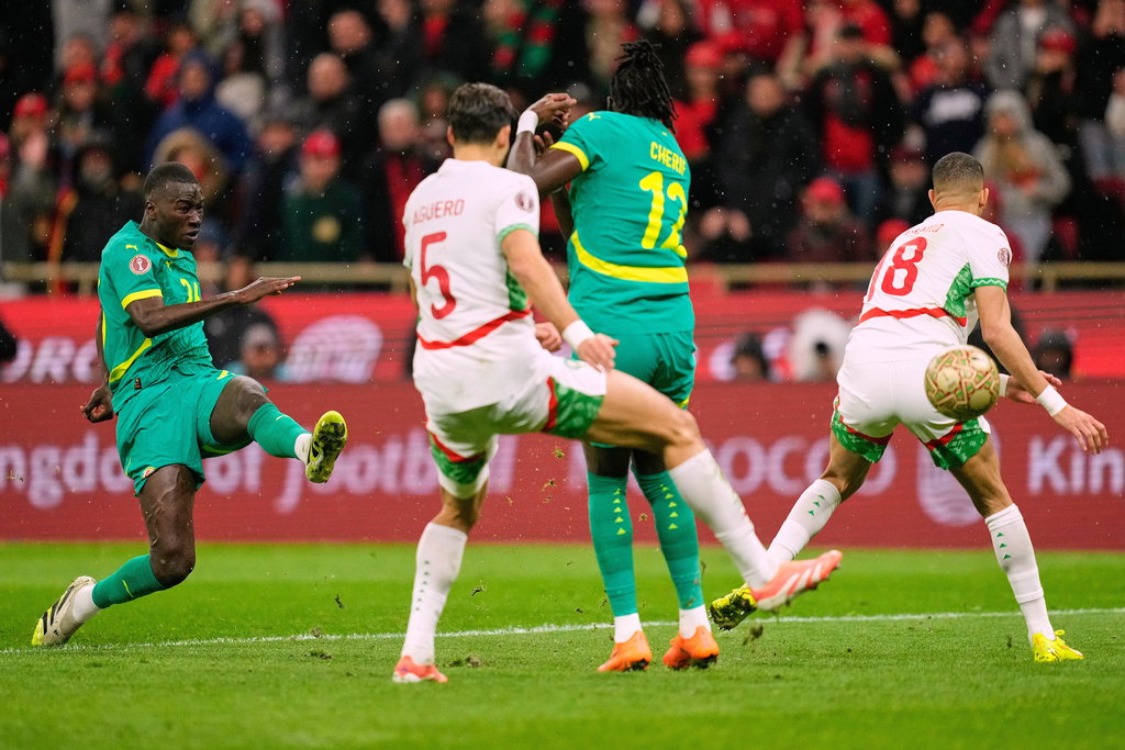FILE - Senegal's Pape Gueye, left, scores the opening goal during the Africa Cup of Nations final soccer match between Senegal and Morocco, in Rabat, Morocco, Jan. 18, 2026. (AP Photo/Mosa'ab Elshamy, File)