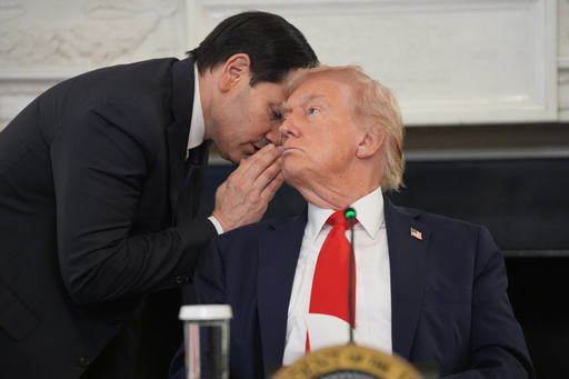 Secretary of State Marco Rubio whispers to President Donald Trump, who is holding the note Rubio handed to him, during a roundtable meeting on antifa in the State Dining Room at the White House, Wednesday, Oct. 8, 2025, in Washington. (AP Photo/Evan Vucci) Secretary of State Marco Rubio whispers to President Donald Trump, who is holding the note Rubio handed to him, during a roundtable meeting on antifa in the State Dining Room at the White House, Wednesday, Oct. 8, 2025, in Washington. (AP Photo/Evan Vucci)