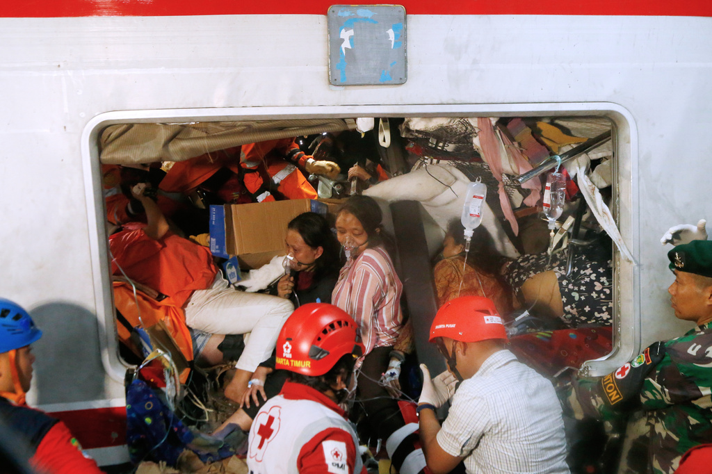 Passengers are being rescued after a train collision in Bekasi, Indonesia, Tuesday, April 28, 2026. (AP Photo)