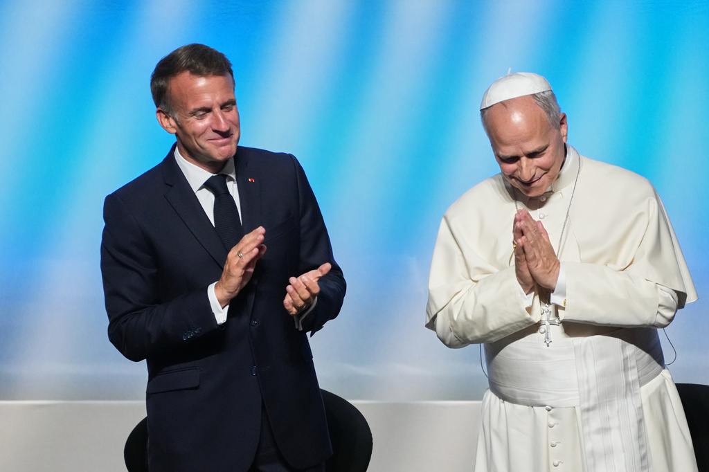 Pope Leo XIV is congratulated by French President Emmanuel Macron, left, after his speech at the meeting At the Roots of Europe for Peace and Unity with, Monday, Sept. 28, 2026, in Metz, France. (AP Photo/Gregorio Borgia)