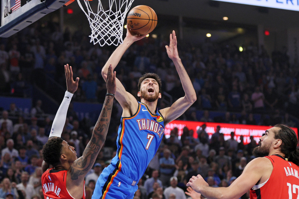 Oklahoma City Thunder center Chet Holmgren (7) looks to shoot over Houston Rockets forward Jabari Smith Jr., left, during the first half of an NBA basketball game Tuesday, Oct. 21, 2025, in Oklahoma City. (AP Photo/Nate Billings)