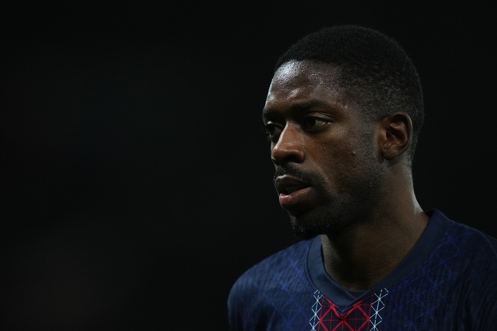 PSG's Ousmane Dembele walks to kick a corner during the French League One soccer match between Paris and Rennes in Paris, France, Saturday, Dec. 6, 2025. (AP Photo/Thibault Camus)