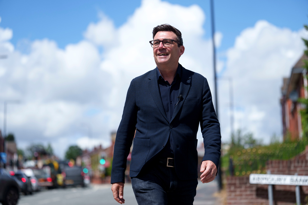 Andy Burnham smiles during a campaign visit to Ashton-in-Makerfield before the forthcoming by-election, in Manchester, England, Tuesday, June 9, 2026. CORRECTION: corrects family name to Burnham instead of Bunham (AP Photo/Jon Super)