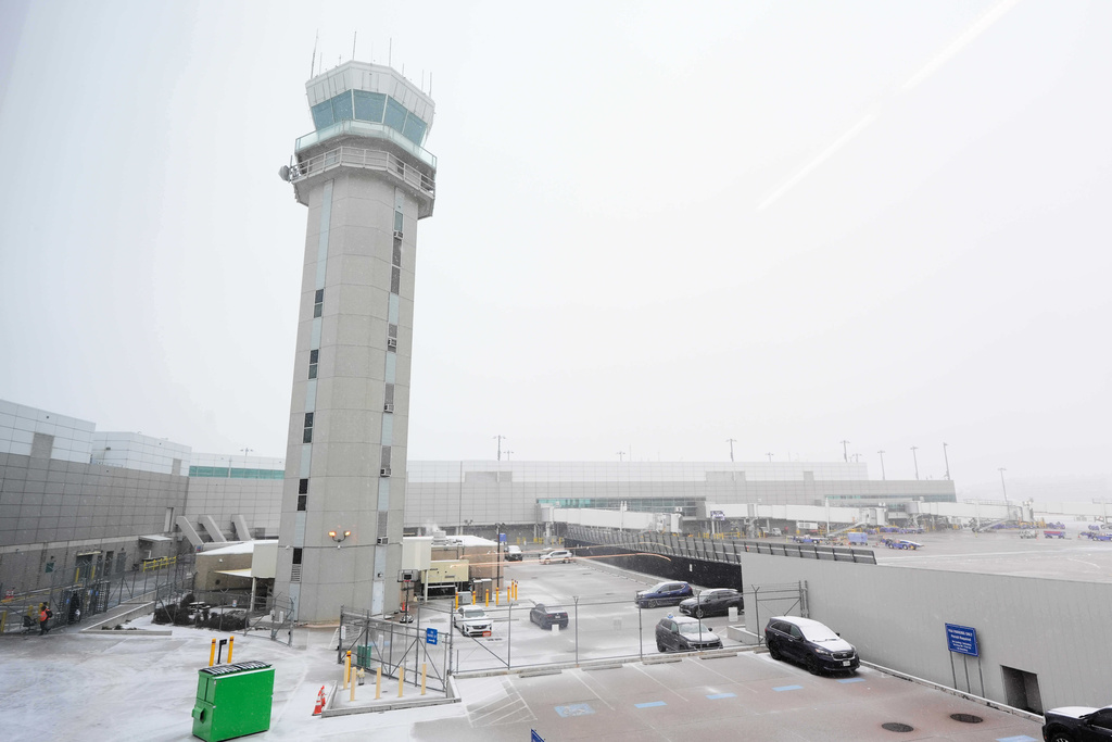 The control tower at Love Field Airport is shown where weather conditions have had an impact on travel in and out of the normally busy airport Saturday, Jan. 24, 2026, in Dallas. (AP Photo/Tony Gutierrez)
