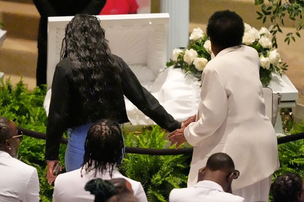 Mourners walk by caskets for the eight children who were killed during a mass shooting last month, during funeral services for the children Saturday, May 9, 2026, at the Summer Grove Baptist Church in Shreveport, La. (AP Photo/Gerald Herbert)