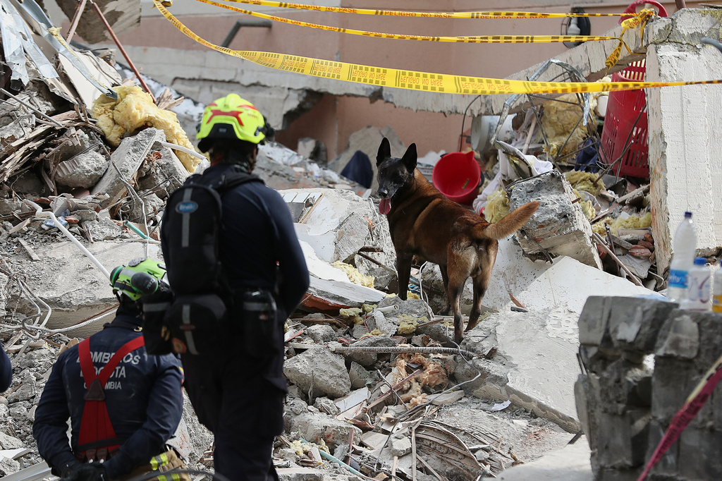 Firefighters search through rubble two days after an earthquake struck Cali, Colombia, Wednesday, Aug. 12, 2026. (AP Photo/Santiago Saldarriaga)