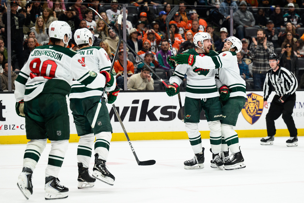 Minnesota Wild center Yakov Trenin, center, is greeted by Minnesota Wild defenseman Brock Faber (7) after scoring during the second period of an NHL hockey game against the Anaheim Ducks, Friday, Jan. 2, 2026, in Anaheim, Calif. (AP Photo/William Liang)