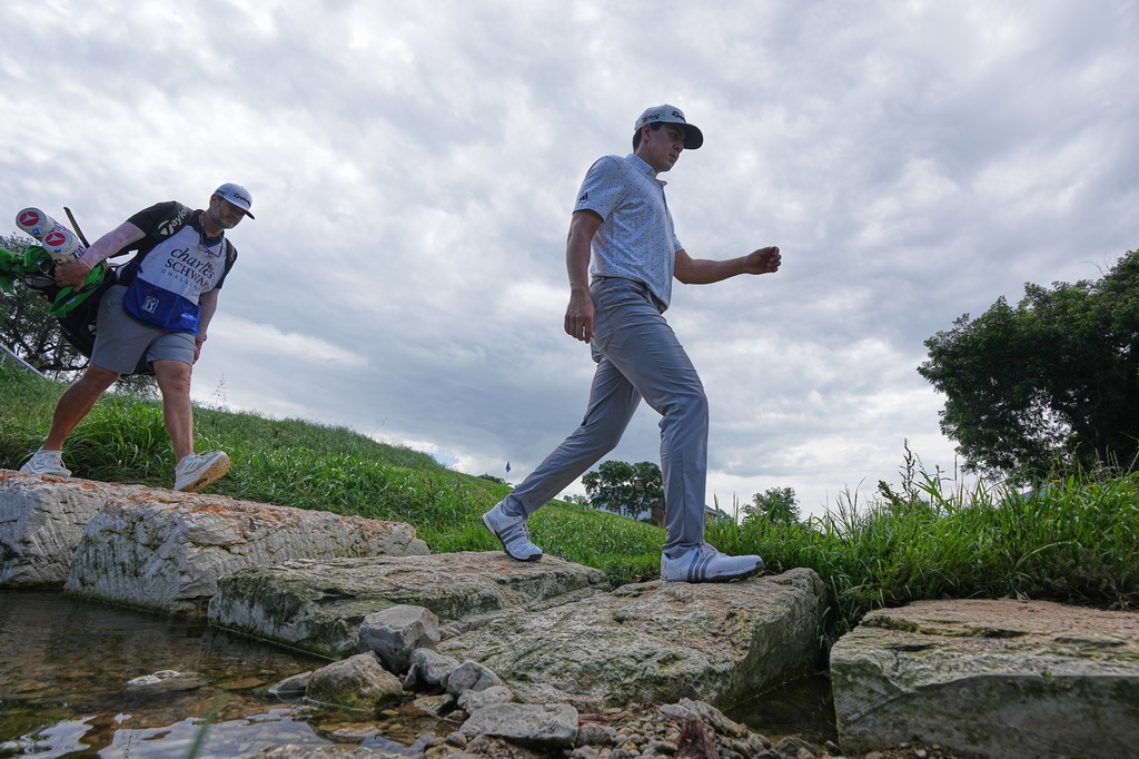 Michael Thorbjornsen walks over a rock footbridge along the 17th hole during the first round of the Charles Schwab Challenge golf tournament at Colonial Country Club in Fort Worth, Texas, Thursday, May 28, 2026. (AP Photo/LM Otero)