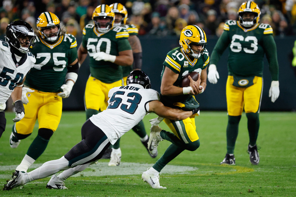 Philadelphia Eagles linebacker Zack Baun (53) tackles Green Bay Packers quarterback Jordan Love (10) during the second half of an NFL football game Monday, Nov. 10, 2025, in Green Bay, Wis. (AP Photo/Mike Roemer)